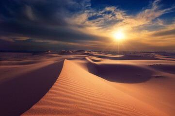 Naklejka na ściany i meble Scenic View Of Sand Dunes Against Sky During Sunset