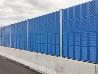 SELANGOR, MALAYSIA - JULY 2, 2020: Noise barriers are installed along the vehicle lane bordering the residence to prevent noise pollution to the locals.