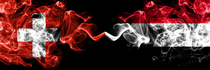 Switzerland, Swiss vs Yemen, Yemeni smoky mystic flags placed side by side. Thick colored silky abstract smoke flags.