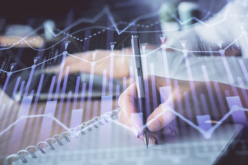 Double exposure of forex chart drawing over people taking notes background. Concept of financial analysis