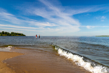 Waves run ashore two women in the water