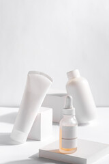 Set of cosmetic products in white containers on light background. Organic skincare.