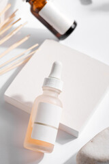 Brown and white glass with dropper on white background. Branding mock-up