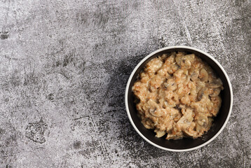 Savory Mushroom Oatmeal in a bowl on a dark background. Top view, flat lay