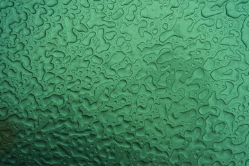 Abstract illustration. Ice or raindrops close up. Macro, strong magnification. The background is green.