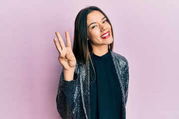 Young hispanic girl wearing party jacket showing and pointing up with fingers number three while...