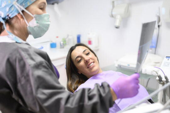 Dentist Explaining The Details Of A X-Ray Picture To Her Patient. High quality photo