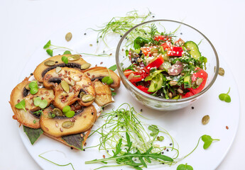 Sandwich with fried mushrooms, basil, pumpkin seeds and microgreens - radish and onion seedlings and tomato and cucumber salad, served with sesame seeds.