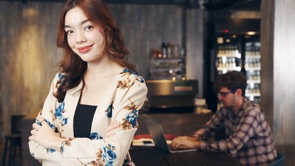 Business owner attractive young Asian woman in apron happy and smile  at  new cafe. 