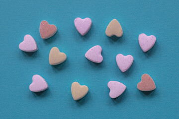 litlle candy hearts  on blue background for valentine's day 