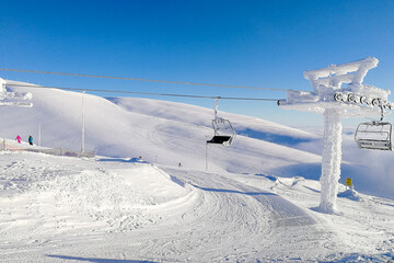 The snow-covered support of the chairlift