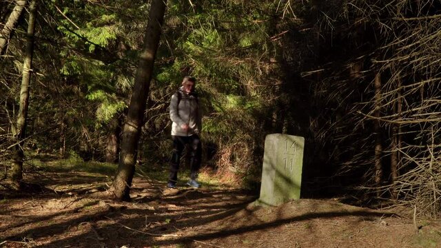 Thurst in the woods near the old border pillar of the Czech-Polish border. Travel concept. Carpathian mountain range. Ukraine. 4K