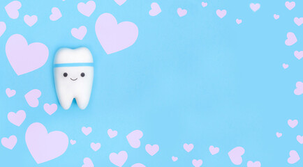 Valentine's day dentistry background banner. Tooth model with copy space with a frame of pink hearts