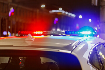 police car lights at night in city with selective focus and bokeh