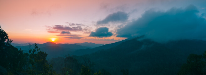 Panoramic mountain landscape. Majestic sunrise of the mountains layer in the morning. Serenity in nature.