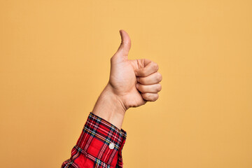 Hand of caucasian young man showing fingers over isolated yellow background doing successful...