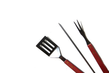 BBQ instruments kit - skewer, spatula, fork - close up isolated on white background flat lay