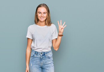 Beautiful young blonde woman wearing casual white t shirt showing and pointing up with fingers number four while smiling confident and happy.