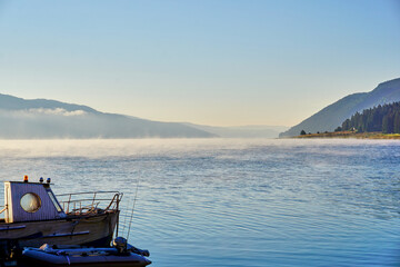 Wooden boat in the lake in the early morning