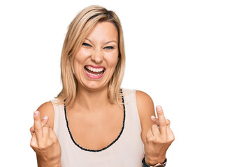 Middle age caucasian woman wearing casual clothes showing middle finger doing fuck you bad expression, provocation and rude attitude. screaming excited