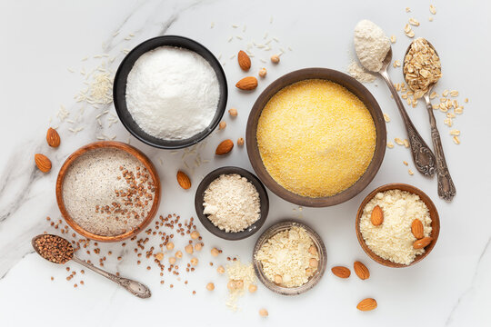 Gluten free concept showing the variety of types of flour - corn, rice, buckwheat, chickpea, almond, chestnut and oatmeal flour.