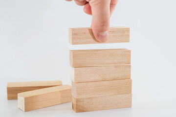 The human hand lays down wooden blocks.