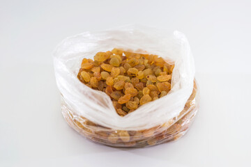 raisins in a plastic bag on a white