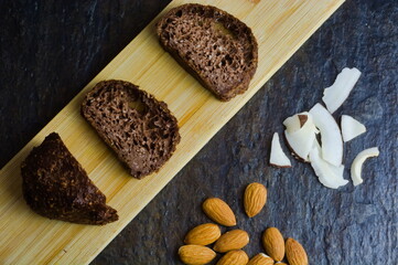 Delicious Chocolate bread brownie and cakes with chocolate and almonds slices on black background. Selective focus. Top view. Home made keto peanut cookies . Ketogenic dessert. Keto diet. Low  carb. 