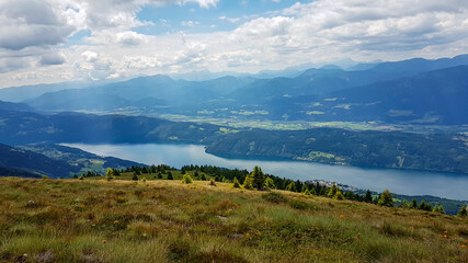 A panoramic view on the Millstaettersee lake from Granattor in Austrian Alps. The distant lake is...