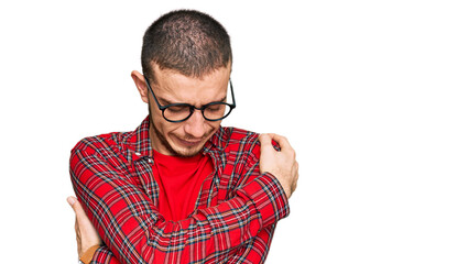 Naklejka premium Hispanic young man wearing casual clothes hugging oneself happy and positive, smiling confident. self love and self care
