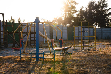 small park with playgrounds abandoned by the pandemic, in a sunset