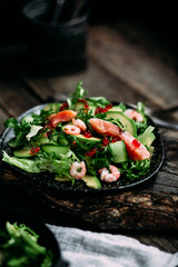 Salad with shrimps, salmon, avocado and red caviar