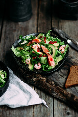 Obraz na płótnie Canvas Salad with shrimps, salmon, avocado and red caviar