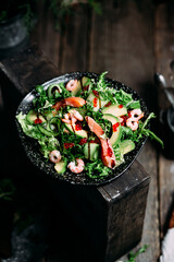 Salad with shrimps, salmon, avocado and red caviar