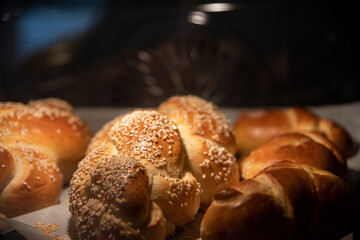 Baking homemade challah bread. Braid challah with sesame seeds on a baking sheet in the oven. High quality photo