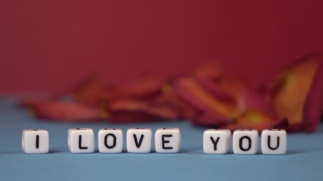I love you against the background of rose petals . Valentine's Day. Background concept of love and beauty