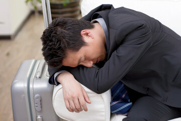 Obraz premium Businessman resting head on pile of boot