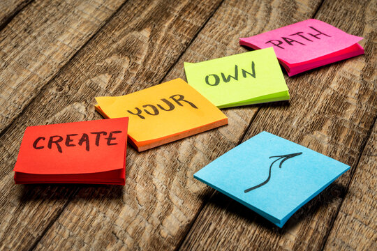 create your own path inspirational text - handwriting on sticky reminder notes against rustic wood, lifestyle, career and personal development concept