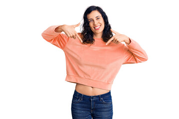 Young beautiful hispanic woman wearing casual clothes looking confident with smile on face,...