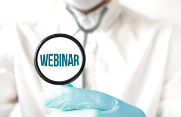 Doctor holding a stethoscope with text WEBINAR, medical concept