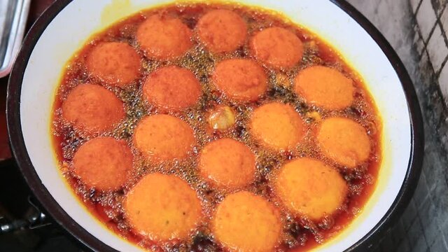 salvador, bahia, brazil - january 8, 2021: acaraje during frying in a pan with palm oil, in downtown Salvador.