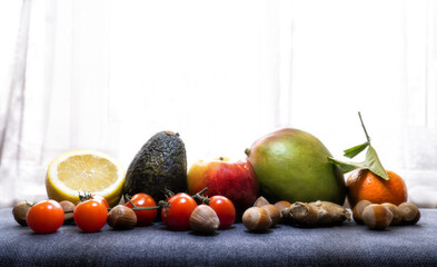 balanced diet, cooking, culinary and healthy food concept - close up of vegetables, tropical fruits and meat on table