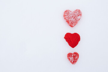 Valentines Day background with hearts. A pair of vintage decorative heart sticking out of the snow surface.