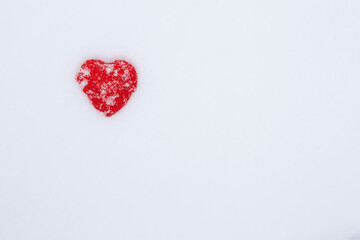 Valentines Day background with hearts. A pair of vintage decorative heart sticking out of the snow surface.