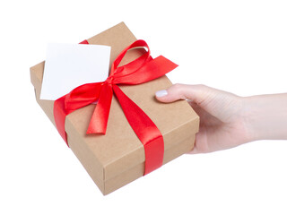 Gift box with red ribbon and white card in hand on white background isolation