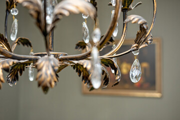 close up detail of crystal pendant chandelier, selective focus, blurred background