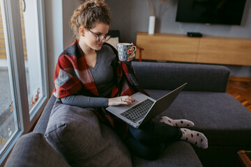 Young woman working at home. Young businesswoman working on laptop. Businesswoman working from home.