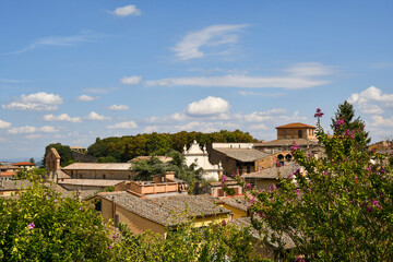 Fototapeta na wymiar Rooftop view of the old Etruscan town of Volterra, a walled mountaintop town in the Tuscany region, with clear blue sky in summer, Pisa, Italy