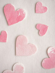 Fototapeta premium Paper hearts painted in pink watercolor on a white background