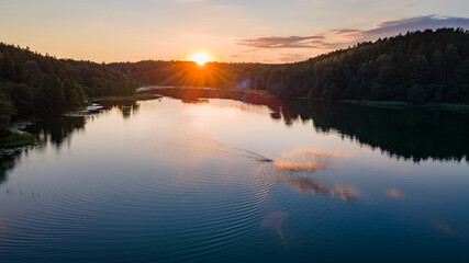 Fototapeta na wymiar Aerial view of beautiful sunset in Lithuania near lake by drone